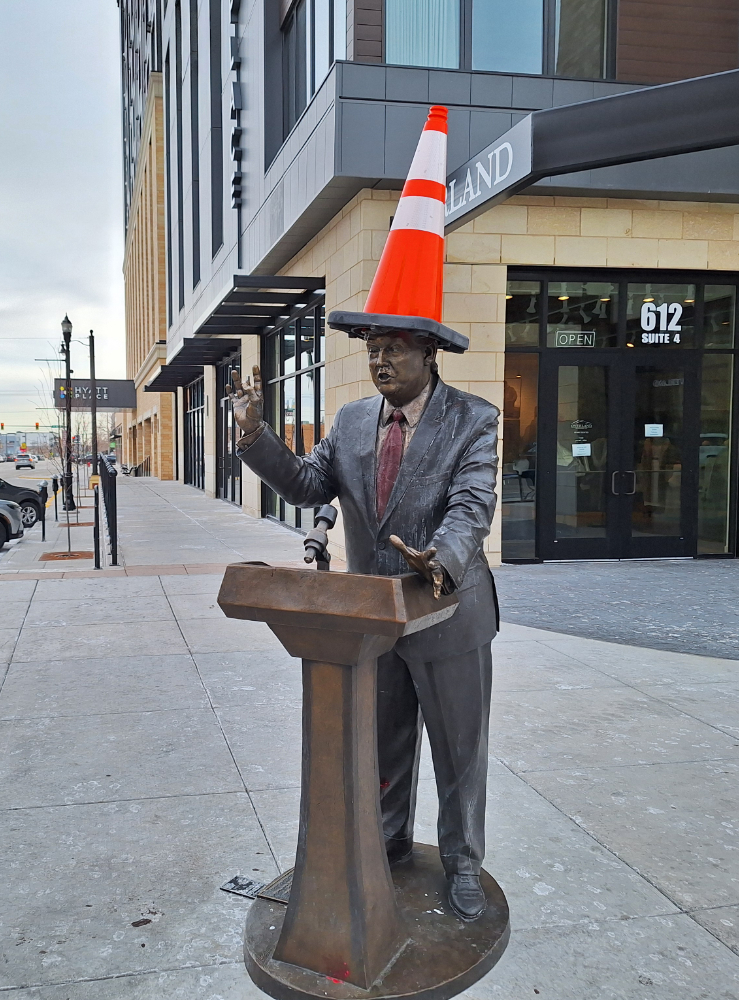 Donald Trump statue with a traffic cone on its head